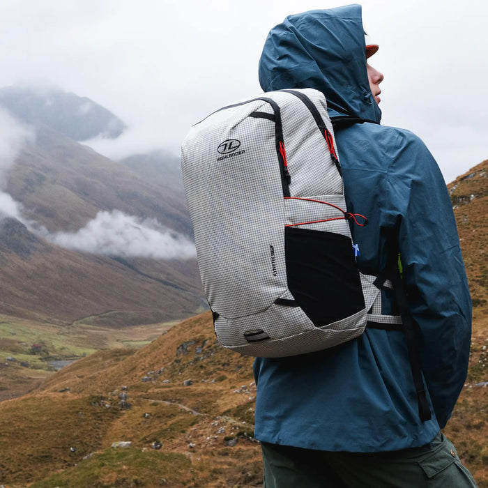 Highlander Kynetik Rucksack 25L in White - side view worn by a hiker looking down a misty glen