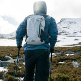 Highlander Kynetik Rucksack 15L in White - worn by a hiker using trekking poles on open moorland