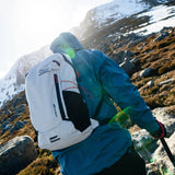 Highlander Kynetik Rucksack 15L in White - side view worn by a hiker climbing towards a snowy summit