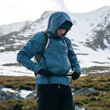 Highlander Kynetik Rucksack 15L in White - worn by a hiker fastening the waist belt on a snowy hillside