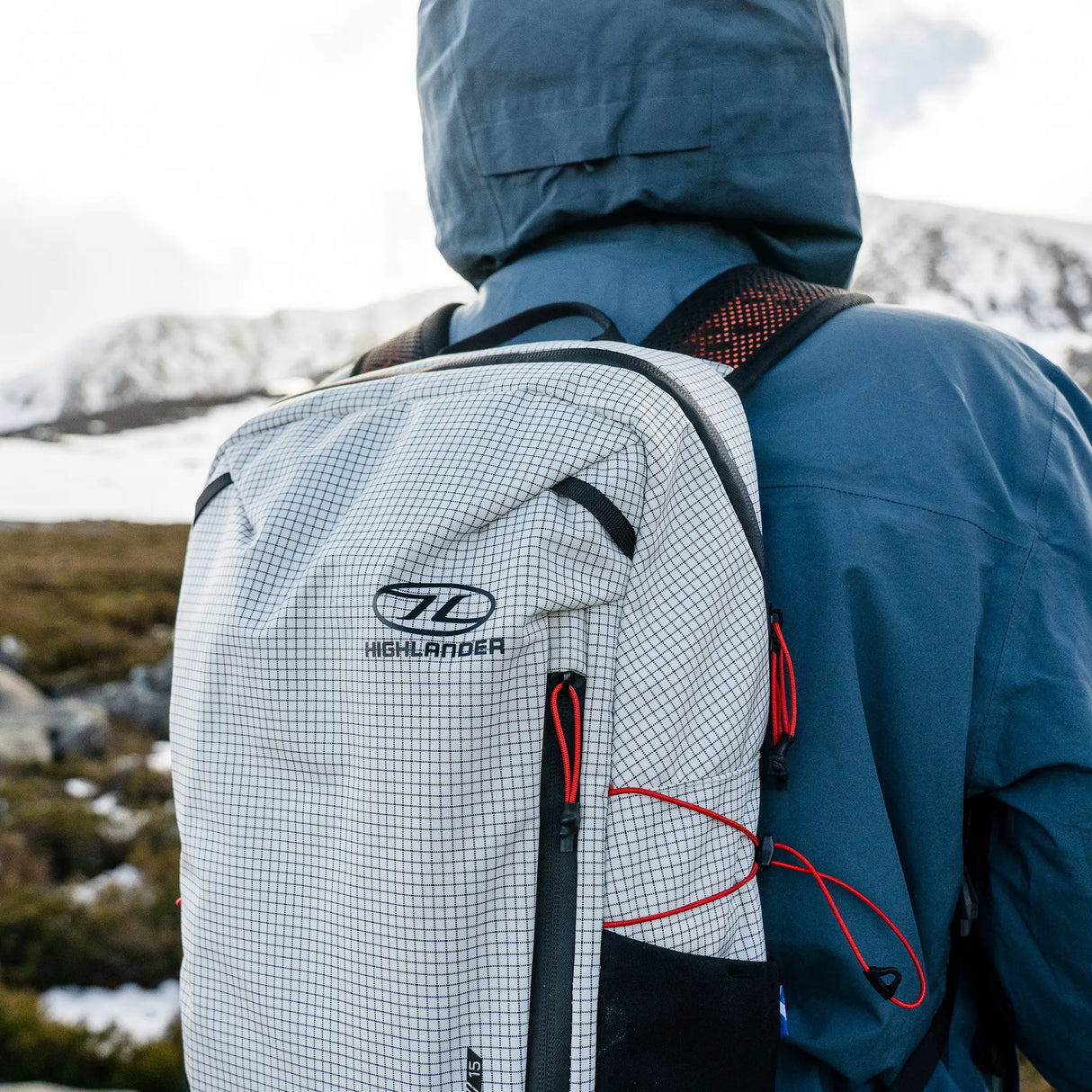 Highlander Kynetik Rucksack 15L in White - rear close-up worn on the hill showing the logo and zip pullers