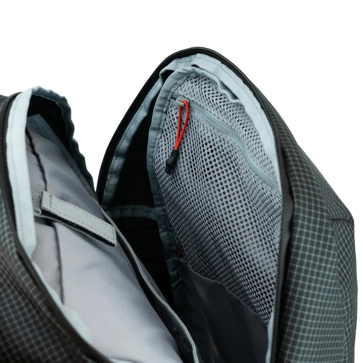 Highlander Kynetik Rucksack 20L in Black - main compartment unzipped showing the grey lining and zipped mesh pocket