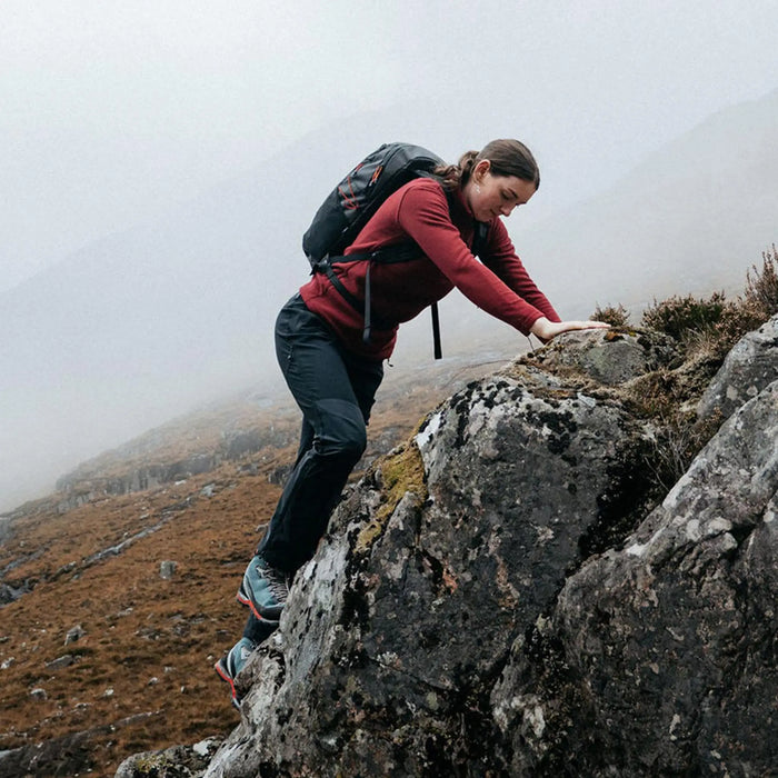Highlander Kynetik Rucksack 20L in Black - worn by a hiker scrambling over rock in low cloud