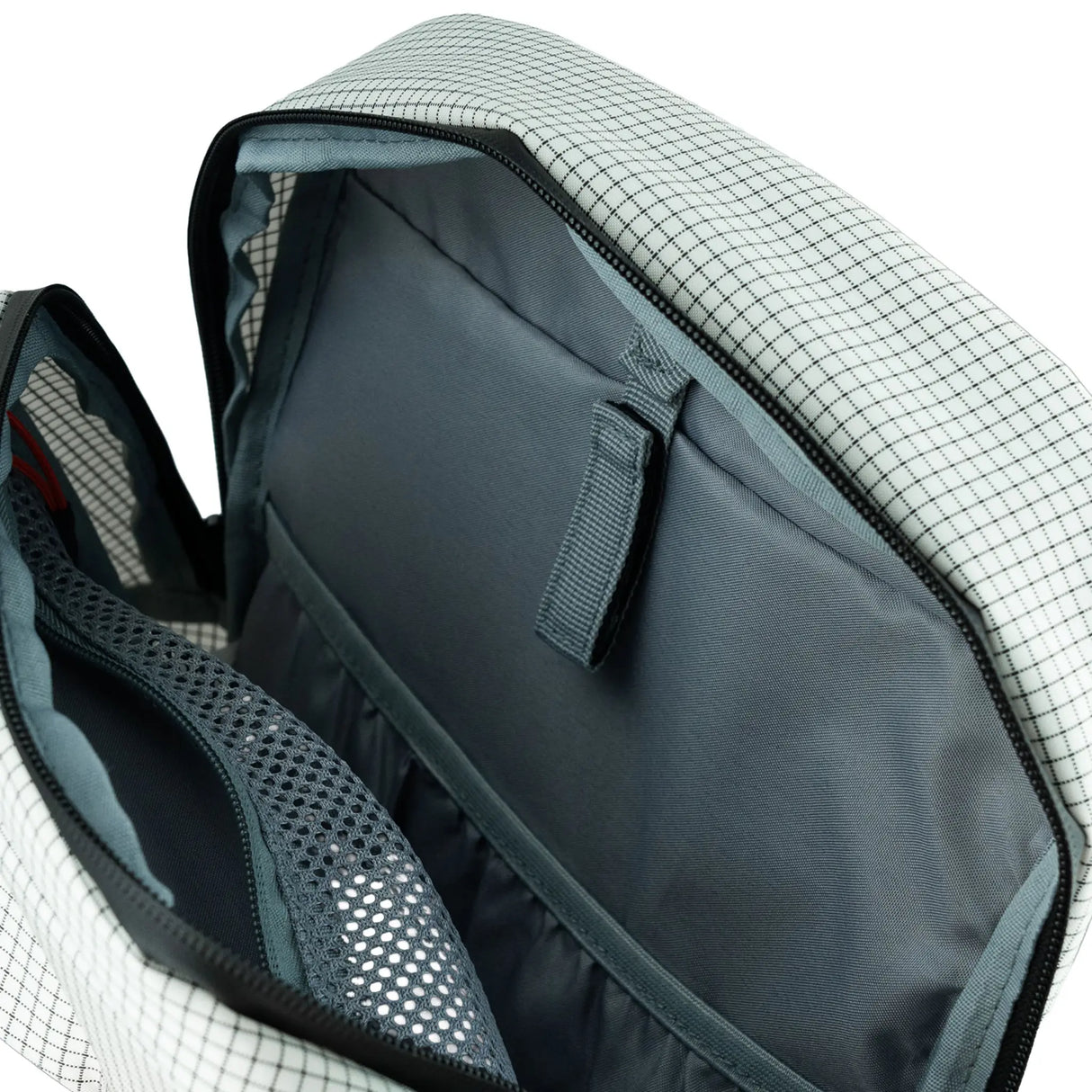 Highlander Kynetik Rucksack 20L in White - main compartment unzipped showing the grey lining and internal sleeve