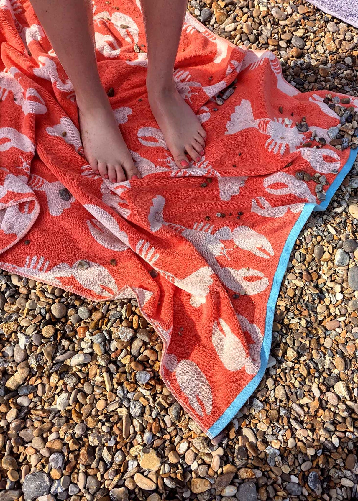 Anorak Lobsters Organic Cotton Towel - Coral and pink bath mat in use