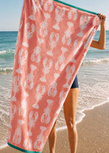 Anorak Lobsters Pink Organic Cotton Towel - Soft pink and white carried on the beach