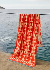 Anorak Lobsters Organic Cotton Towel - Coral and pink hanging by the sea