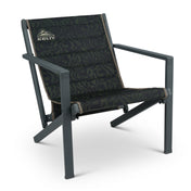Kelty Rad-Arondack Chair in Black Fern, angled view, dark green and black fern-print seat with tan trim on a charcoal frame