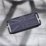 Black 3D printed mini Union Jack patch on a grey wooden surface