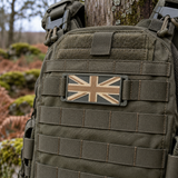 Green/Tan mini Union Jack patch mounted on the MOLLE front of a green plate carrier