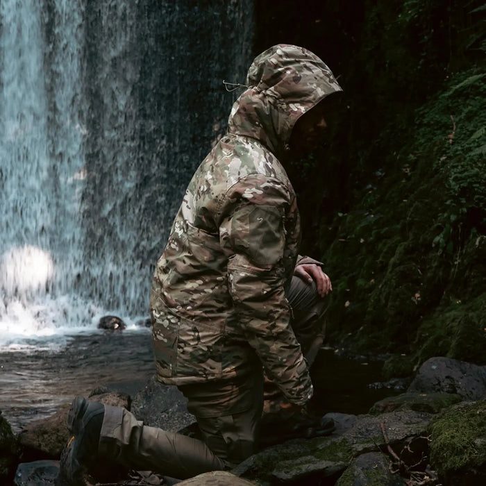 Stoirm Mission Primaloft All Weather Jacket in Multicam lifestyle crouched down in the outdoors