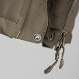 Stoirm Mission Primaloft All Weather Jacket in Ranger Green close up of lower zip with button