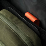 Detail inside a Stoirm pack showing an Olive Green Eco-System pouch seated against the black hook and loop lining where the Large MOLLE Panel mounts