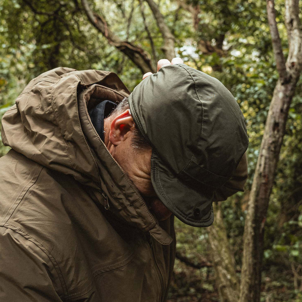 Highlander Waterproof Mountain Hat - worn at night with a head torch strapped over the peak while packing a rucksack