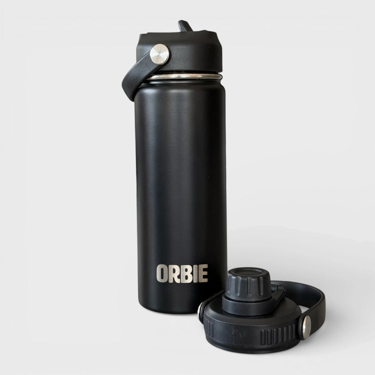 Orbie 18oz insulated water bottle in black with the sip lid fitted and the chug lid standing alongside