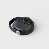 Orbie bottle sip lid closed, with the fold-down spout lying flat in its recess