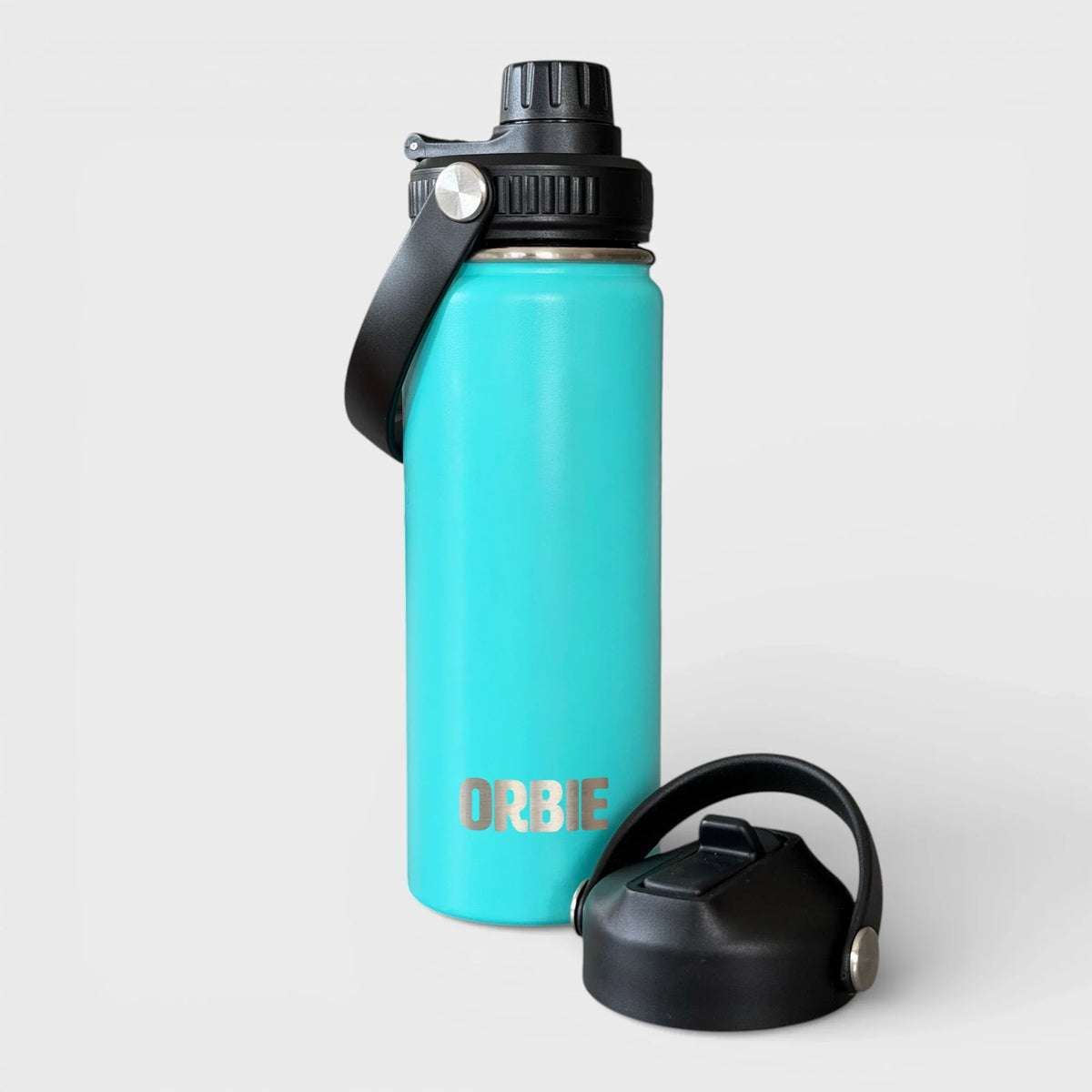 Orbie 18oz insulated water bottle in turquoise with the chug lid fitted and the sip lid standing alongside