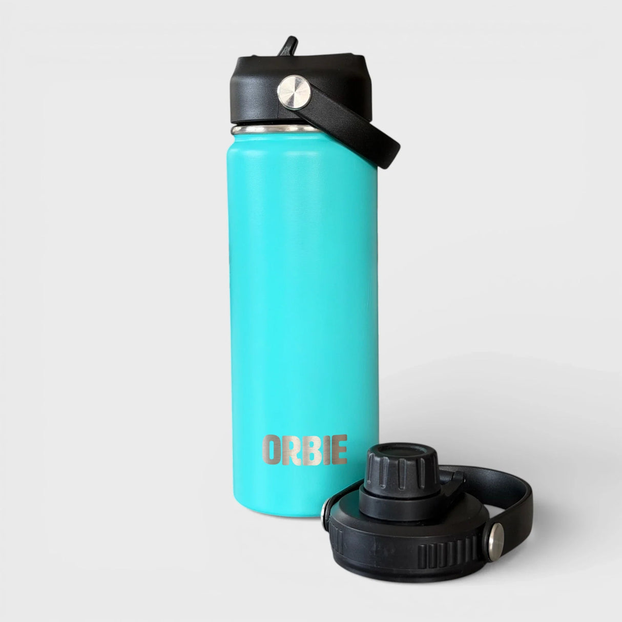 Orbie 18oz insulated water bottle in turquoise with the sip lid fitted and the chug lid standing alongside