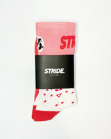 Stride Flash Pink running sock folded in its black STRIDE card sleeve