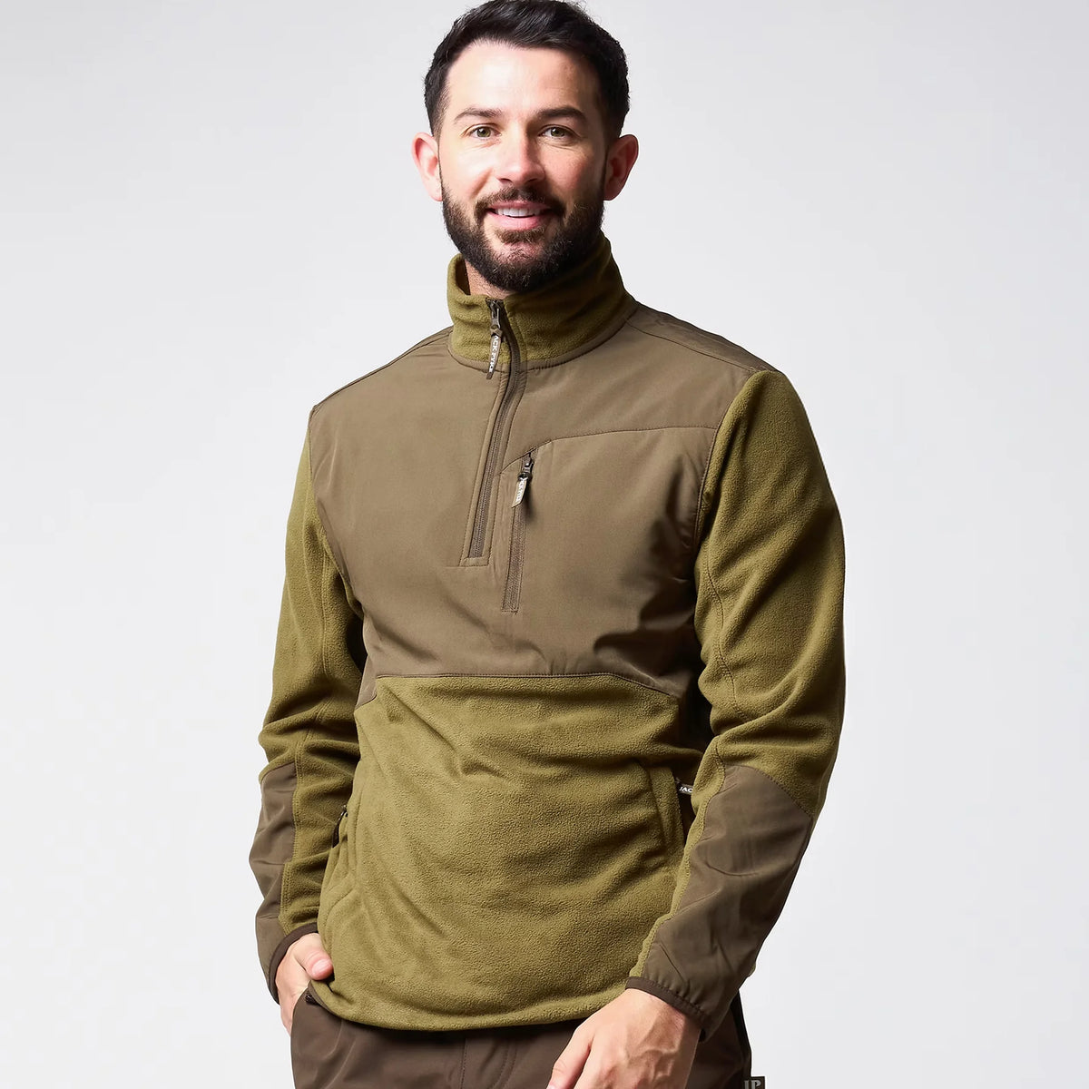 Jack Pyke Rannock Fleece Pullover in dark mustard worn by a model, smiling front view with the smooth contrast forearm panels