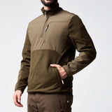 Jack Pyke Rannock Fleece Pullover in dark olive worn by a model, side angle with a hand in a zipped lower pocket