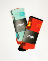 Stride Ocean Wave and Heat Surge running socks side by side in black STRIDE card sleeves