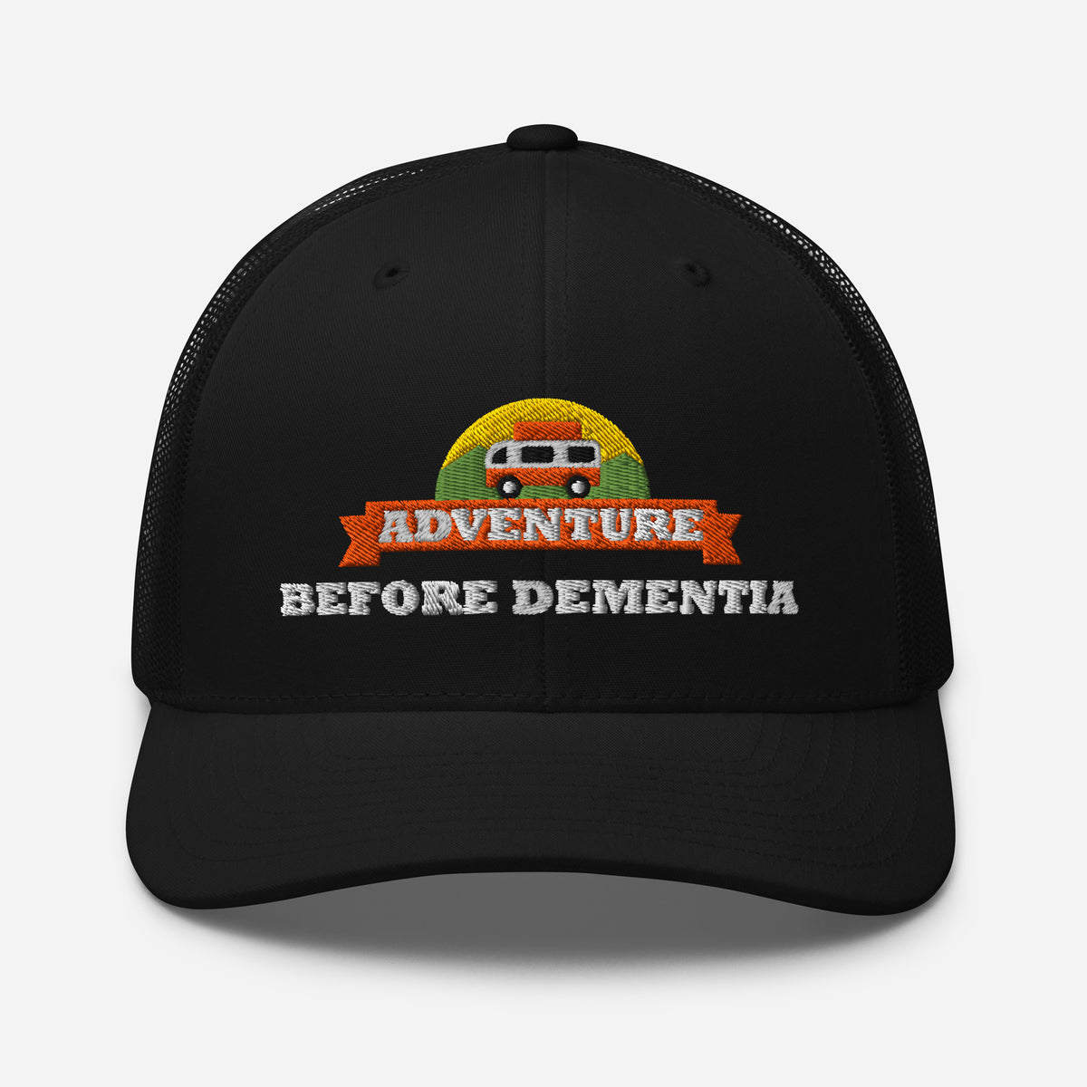 Adventure Before Dementia Trucker Cap in Black, front view showing the structured crown and pre-curved peak