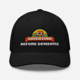 Adventure Before Dementia Trucker Cap in Black, front view showing the structured crown and pre-curved peak
