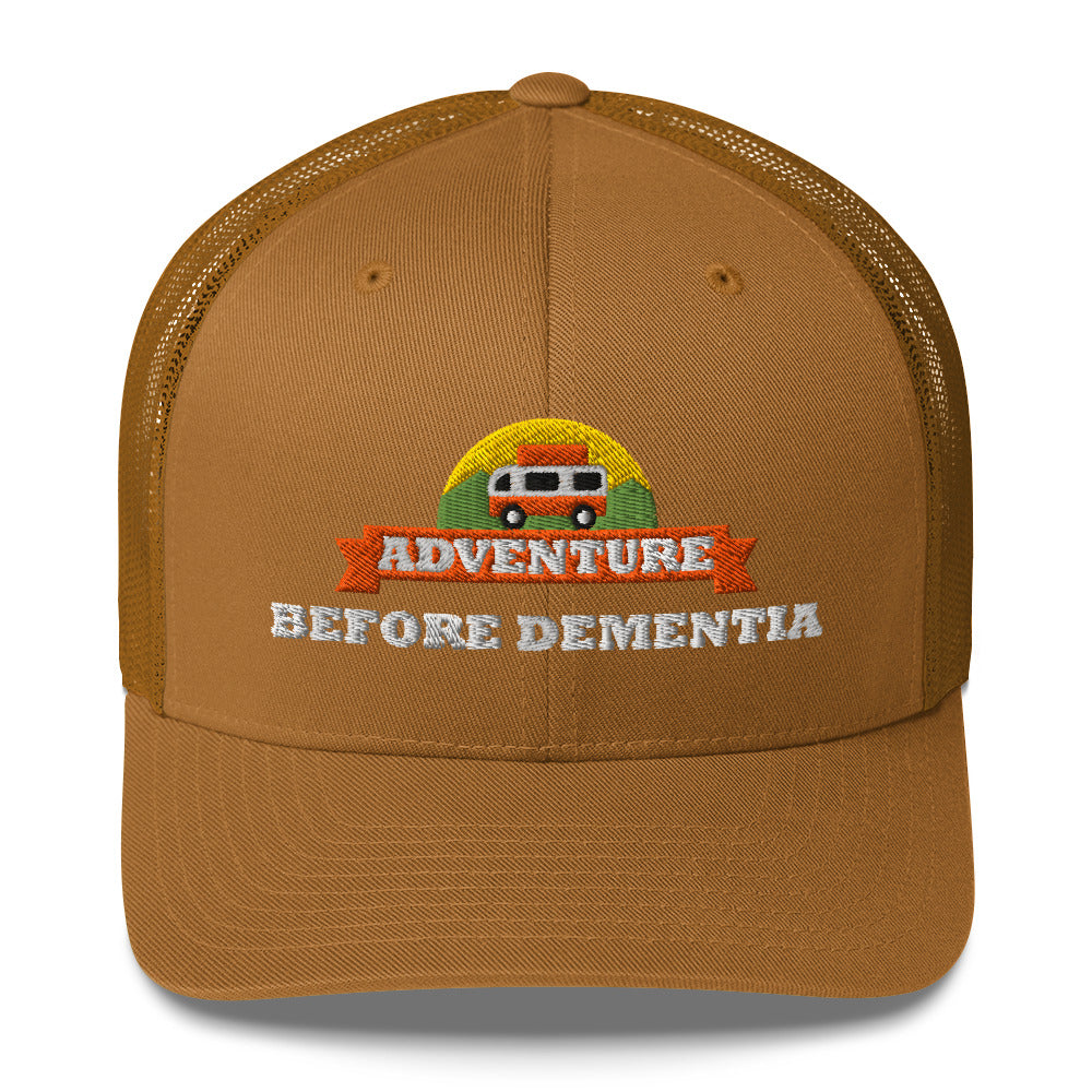 Adventure Before Dementia Trucker Cap in Caramel, front view of the embroidered badge