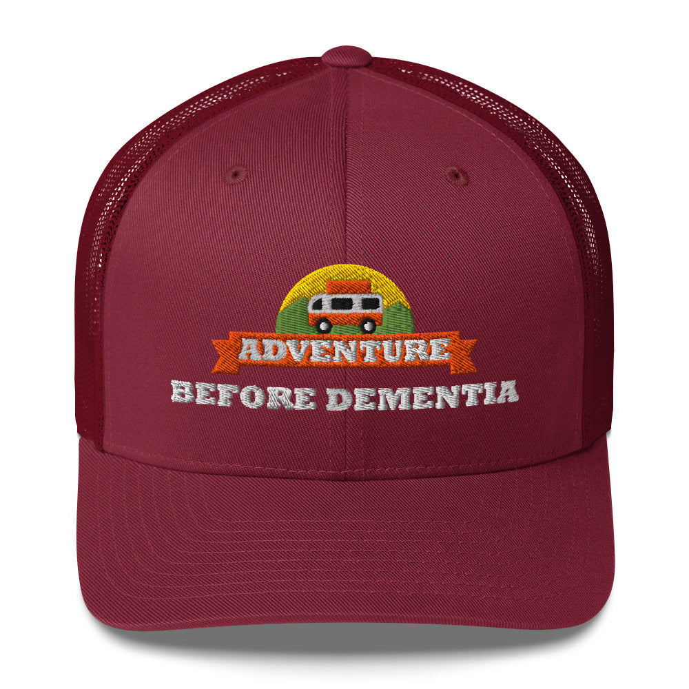 Adventure Before Dementia Trucker Cap in Cranberry, front view of the embroidered badge
