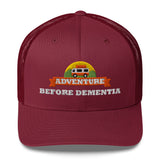 Adventure Before Dementia Trucker Cap in Cranberry, front view of the embroidered badge