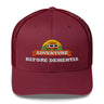 Adventure Before Dementia Trucker Cap in Cranberry, front view of the embroidered badge