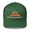 Adventure Before Dementia Trucker Cap in Evergreen, front view of the embroidered badge