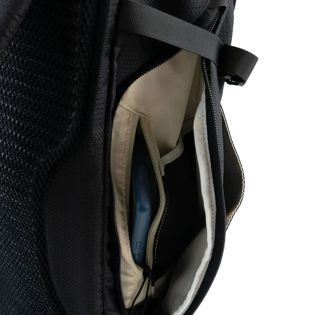 Highlander Roam Backpack 28L in black close up of the zip side pocket on white background