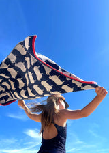 Anorak Kissing Sheep Organic Cotton Towel - Navy blue and white carried on the beach