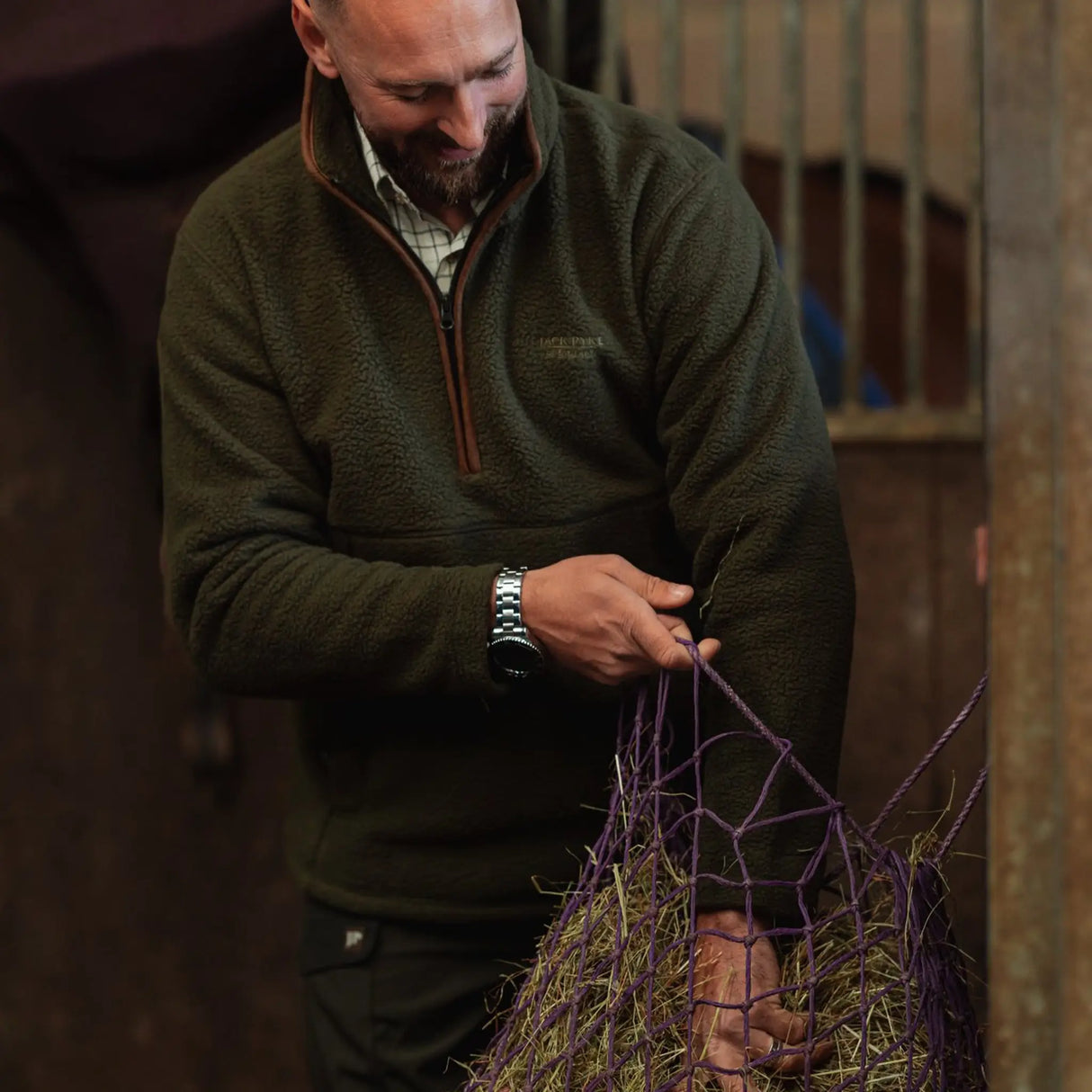 Jack Pyke Half Zip Sherpa Fleece Pullover on a man working on a farm