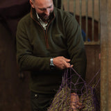 Jack Pyke Half Zip Sherpa Fleece Pullover on a man working on a farm