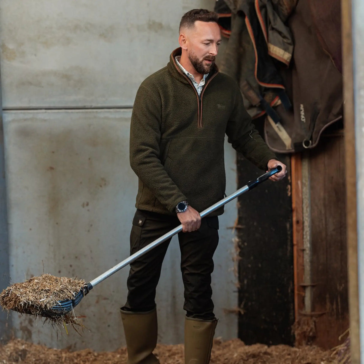 Jack Pyke Half Zip Sherpa Fleece Pullover on a man working on a farm