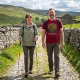 Couple laughing on a Yorkshire Dales walled lane, the man wearing the Sloth Hiking Club: Walking T-Shirt in Cardinal