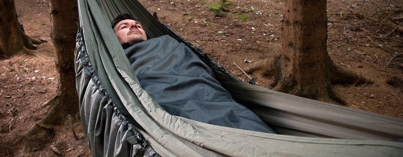 Snugpak Hammock Insulation Explained; Man in Hammock with Insulation