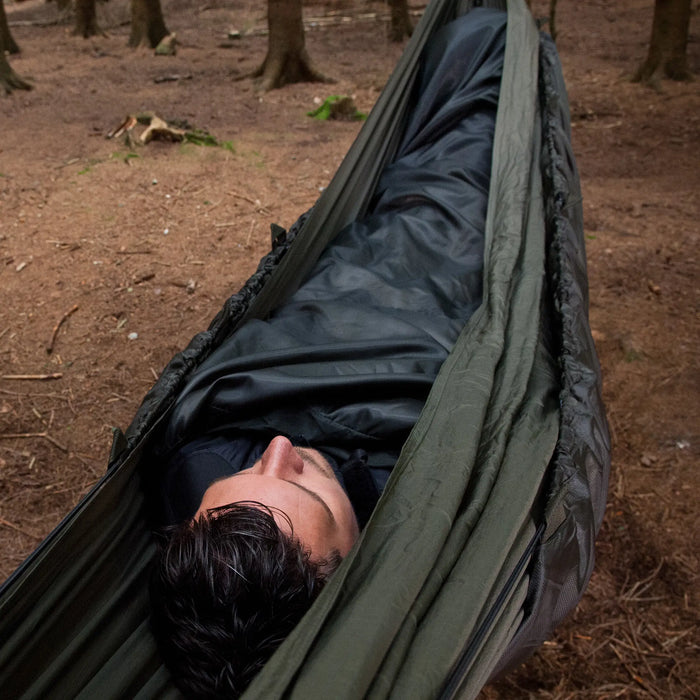 Sungpak Hammock Quilt in the outdoors with a man sleeping below