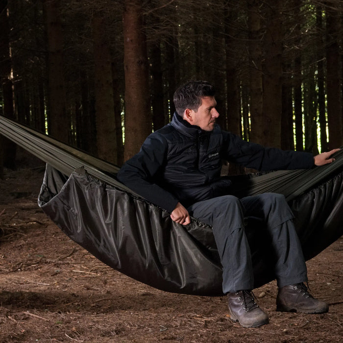 Snugpak Hammock Under Blanket: In the outdoors with a man sitting in hammock