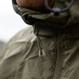 Highlander Stow & Go Pack Away Jacket - close up of zip puller on man in the outdoors