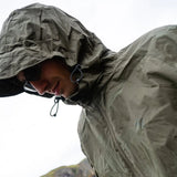Highlander Stow & Go Pack Away Jacket - with hood up on man in the outdoors on rainy day