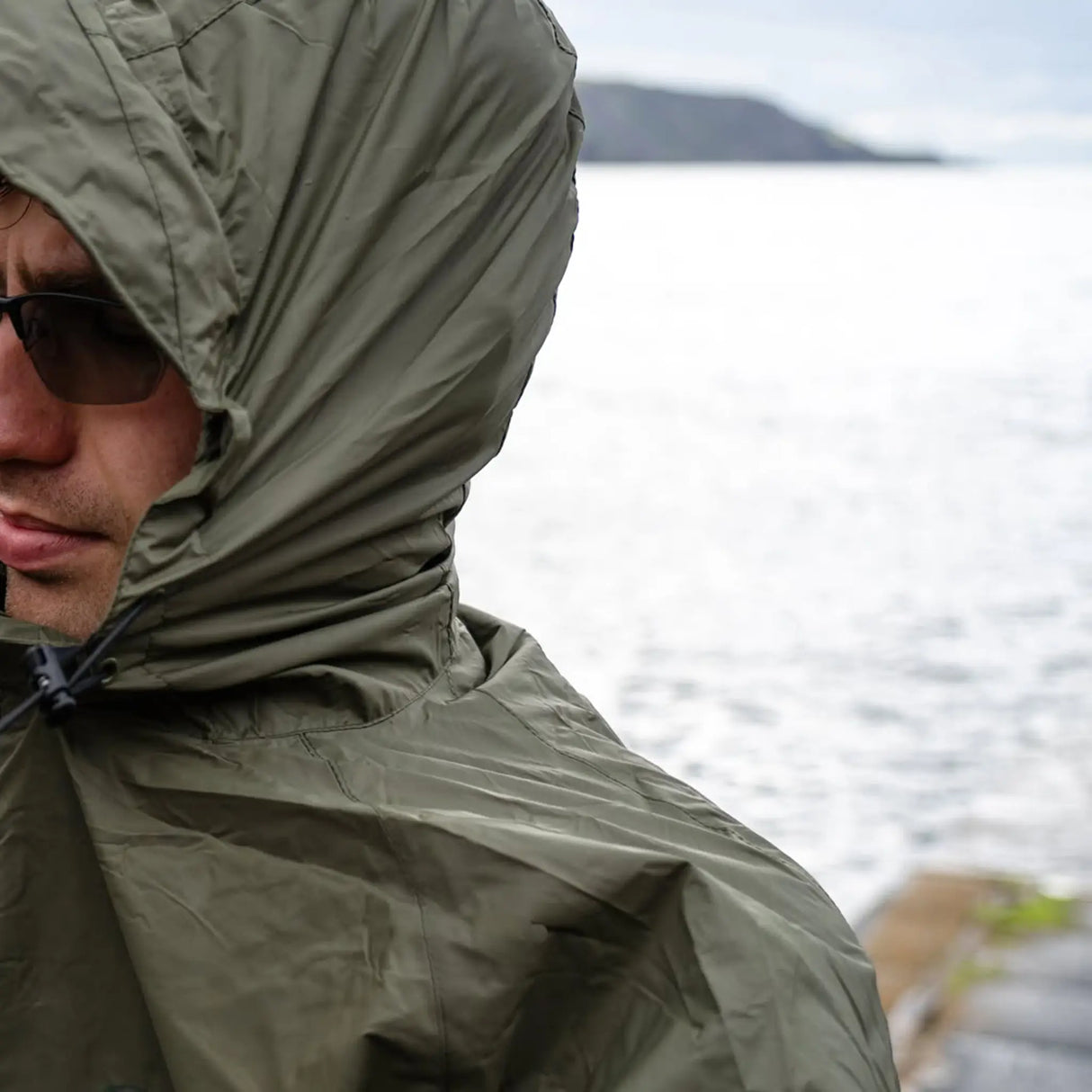 Highlander Stow & Go Pack Away Jacket - close up of hood on man in the outdoors