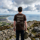 Walker in the Brown Slieve Donard T-shirt by the Mourne Wall, back print facing the camera, looking down to Newcastle