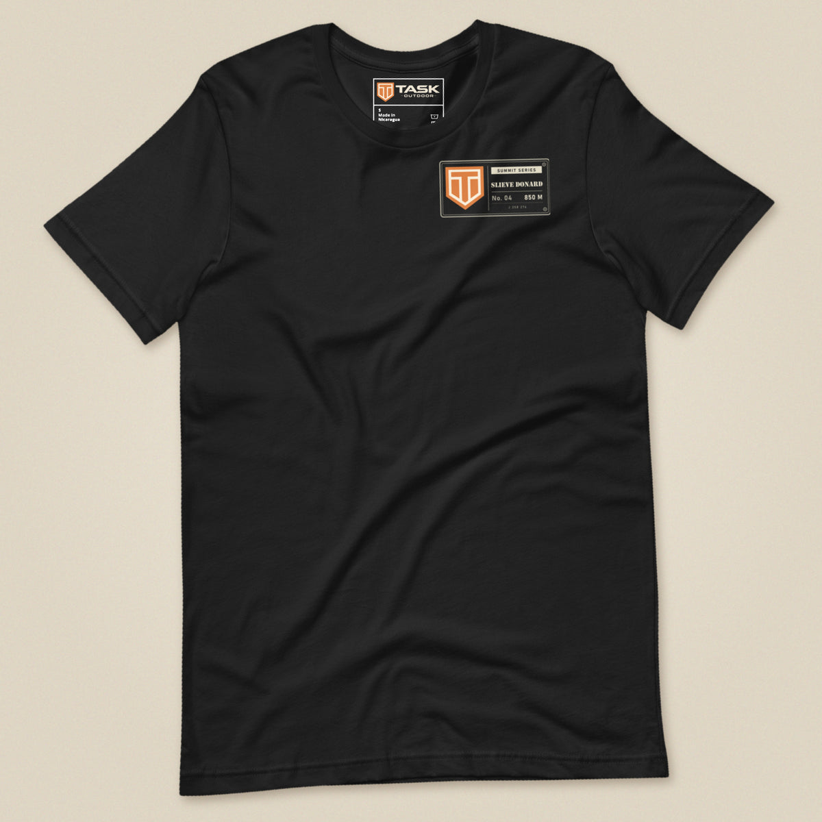 Summit Series Slieve Donard T-Shirt in Vintage Black, laid flat, front view with the left-chest badge and Task Outdoor neck label