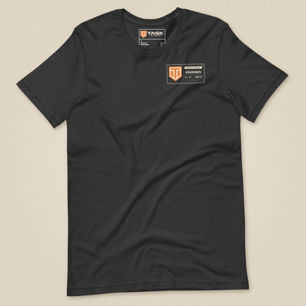 Summit Series Snowdon T-Shirt in Dark Grey, laid flat, front view with the left-chest badge