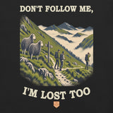 Don't Follow Me, I'm Lost Too Unisex T-Shirt in Vintage Black, close-up of the front print: lost walkers heading into the mist while two Herdwick sheep look on