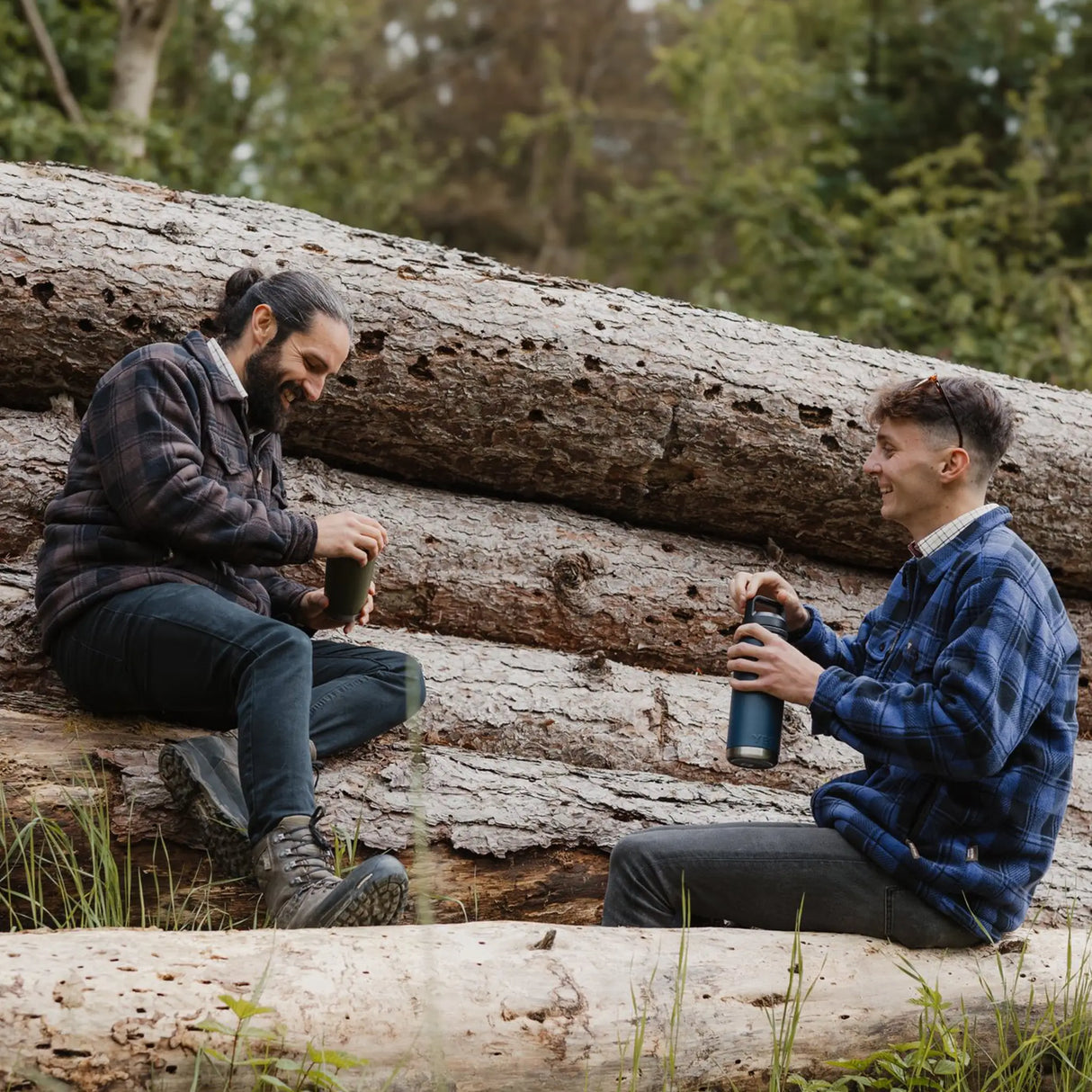 Jack Pyke Tundra Shirt in brown and blue on two men sat outdoors on logs